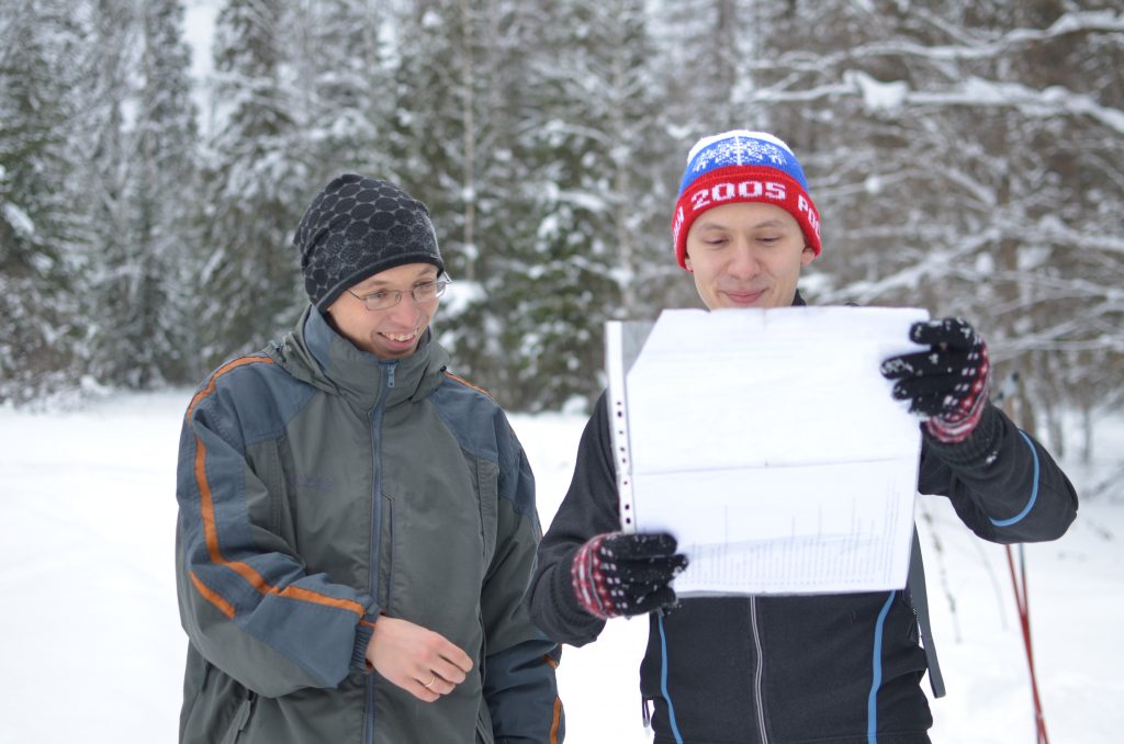 Aleksey and a friend, reviewing a map of their ski route, near Perm, Russia.