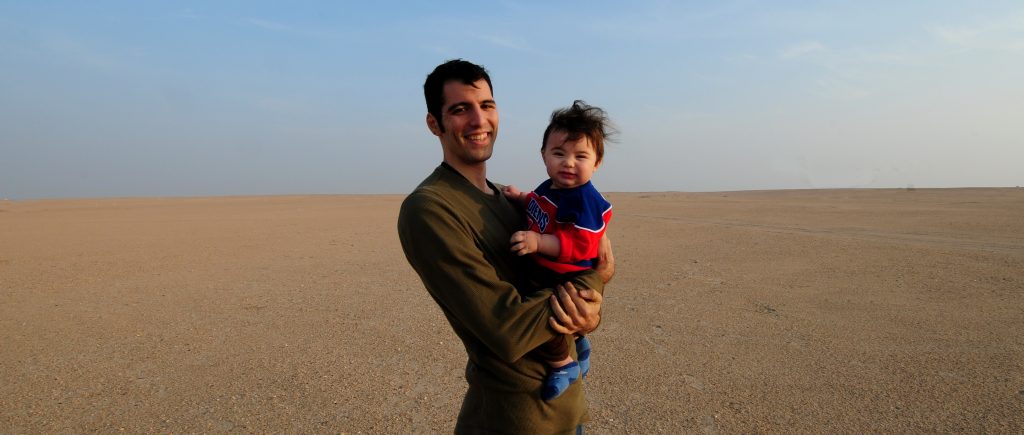 Adriano and his son, at a weekend desert barbecue, in Kuwait.